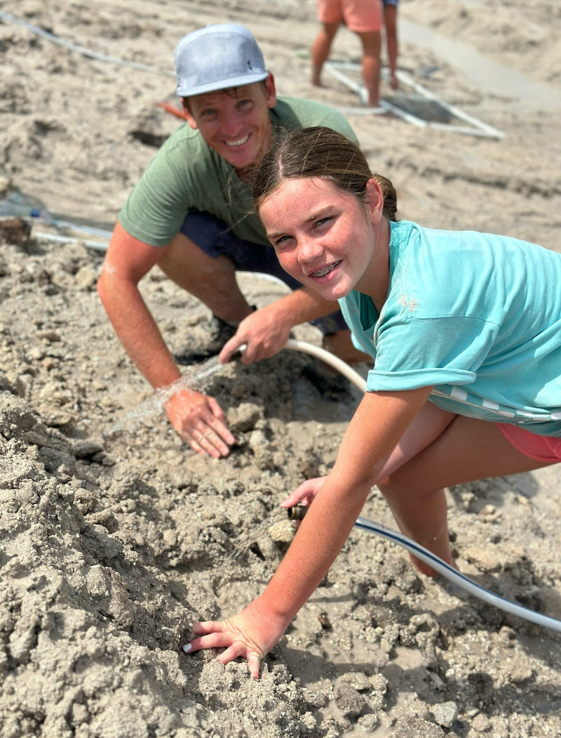 excavating sand and earth with water hoses