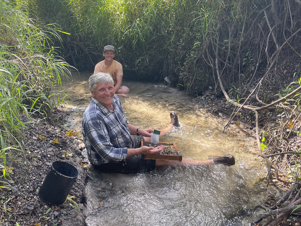 Ron the fossil hunter sits right in the water to get after some fossils